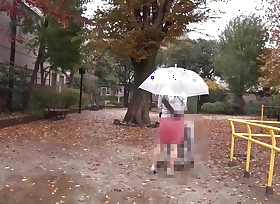 A woman soaked in the rain, wetting her pussy.