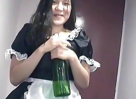 Young Asian girl dressed as a maid indulges herself in a bottle be expeditious for champagne on camera for you